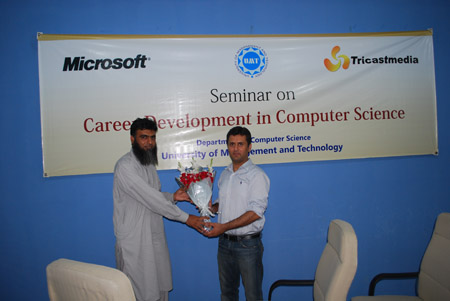Mubasher Baig, Chairperson, Department of Computer Science, presents bouquet to Ali Malik